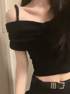 Sort skulderfri crop top der viser kort længde over taljen, nærbillede — Venzelo
