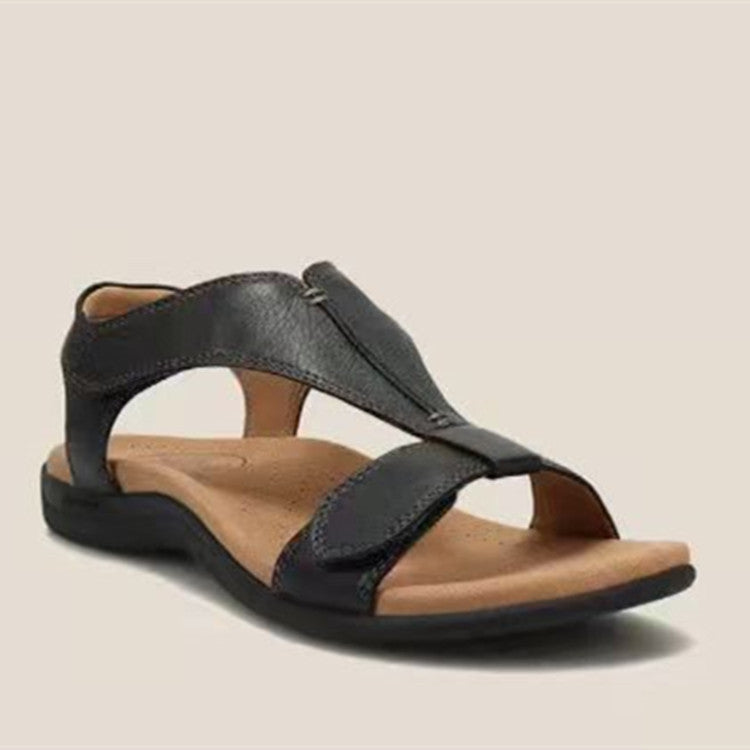Marineblå sandal liggende på vægt, nærbillede der viser sål og velcro-detalje — Venzelo